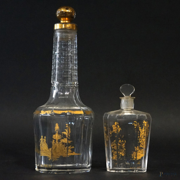 Baccarat, due bottigliette porta-profumo in vetro, particolari dorati,  alt.max cm 20, XX secolo, marcate sotto la base, (segni del tempo).