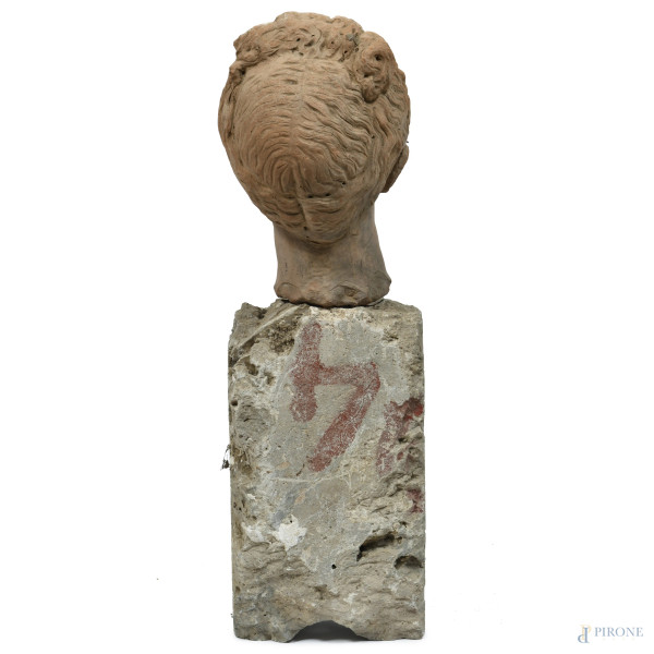 Testa virile in terracotta su base in pietra, XX secolo, altezza cm 82, (difetti, sbeccature, sca...