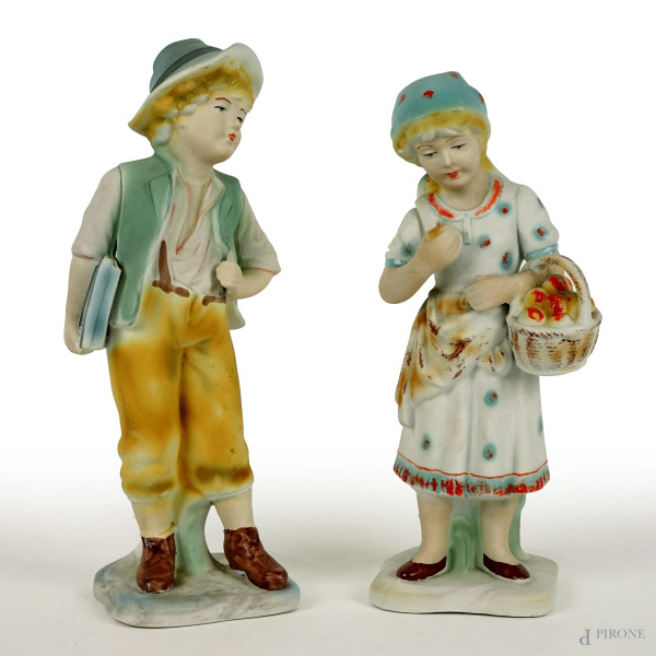 Lotto di due sculture in biscuit raffiguranti fanciulli, alt. max cm 28, XX secolo