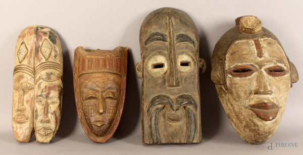 Lotto composto da quattro maschere africane in legno, altezza max. 57 cm.