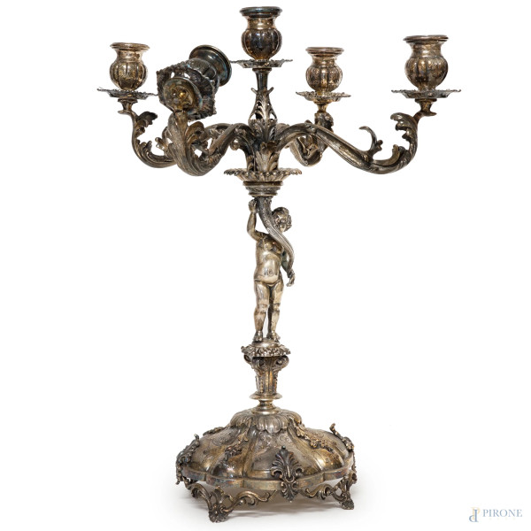 Candelabro a cinque fiamme in argento 800, Milano, seconda metà XX secolo, base sagomata con particolari incisi,  fusto sorretto da putto, quattro bracci lavorati a foggia di volute, cm h, 48,5, peso gr. 2650 circa, (parte rotta).