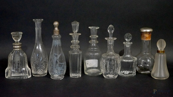 Lotto composto da nove boccette porta profumo in vetro e cristallo, finiture in argento, alt.max cm 20,5, XX secolo, (segni del tempo, due tappi mancanti).