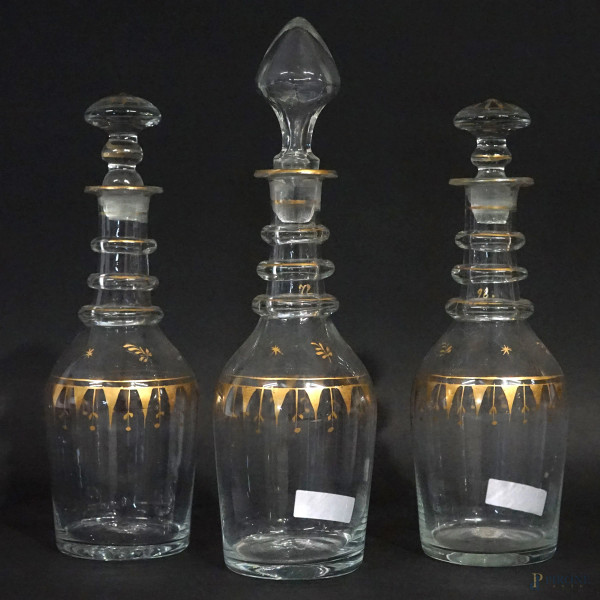 Tre bottigliette in vetro con particolari dorati, alt.max cm 26, XX secolo, (segni del tempo).