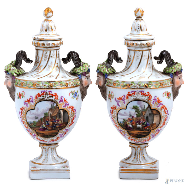 Coppia di potiche in porcellana Sevres decorate con scene di genere e teste di fauno a rilievo, XIX secolo, altezza cm 29, (segni di usura, caduta di smalto)
