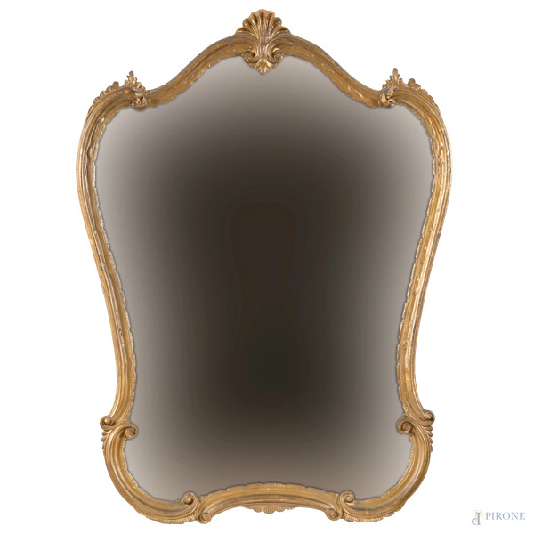Specchiera in legno dorato a profilo sagomato con elemento apicale a conchiglia, XX secolo, cm  102x74,5, (segni di usura)