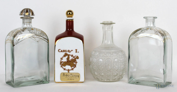 Lotto composto da tre bottiglie da liquore in vetro ed una in porcellana, altezza max cm 21, XX secolo, (difetti, mancanze e restauri).