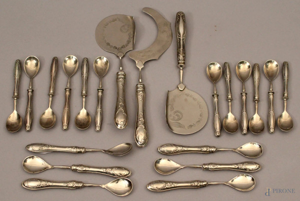 Lotto composto da diciotto cucchiaini e tre posate da portata, con manici in argento.