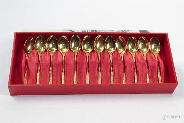 Lotto di dodici cucchiaini in metallo dorato, completo di custodia.