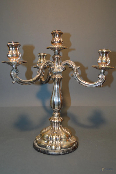Candelabro a quattro luci in argento, poggiante su base in legno, h. 36 cm.