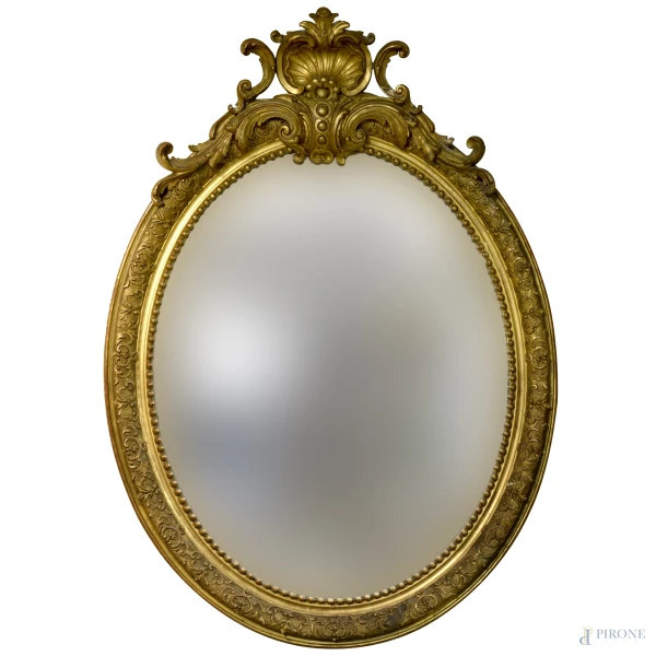 Specchiera di forma ovale in legno intagliato e dorato, inizi del XX secolo, cm 150x100, (difetti) 