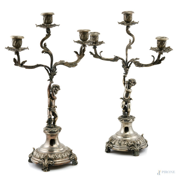 Coppia candelieri in argento 800/000 a tre luci con fusto a guisa di putto, altezza cm 45,5  peso lordo complessivo gr 2600