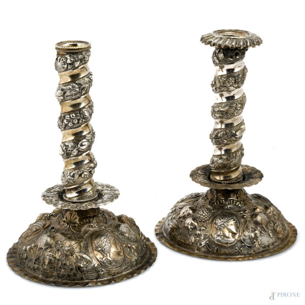 Coppia di candelieri in argento cesellato e sbalzato a torchon con girali e profili di imperatori, XX secolo, altezza massima cm 24,5 , peso lordo complessivo gr 910, (mancante di un portacero)