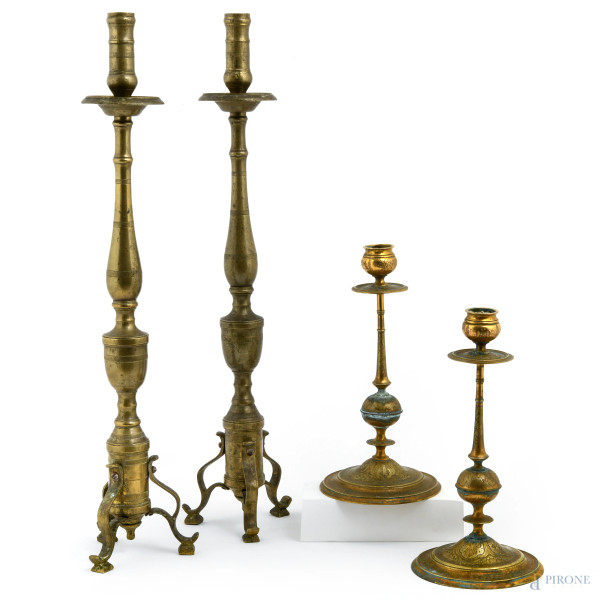 Lotto composto da due coppie di candelieri in metallo, XX secolo, altezza massima cm 50, (segni di usura, ossidazione, difetti)