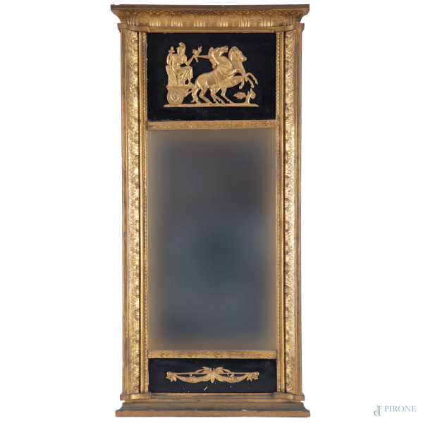 Specchiera in stile Impero in legno intagliato, dorato e laccato nero, XX secolo, misure complessive cm 112,5x53, (scalfiture, cadute di doratura)