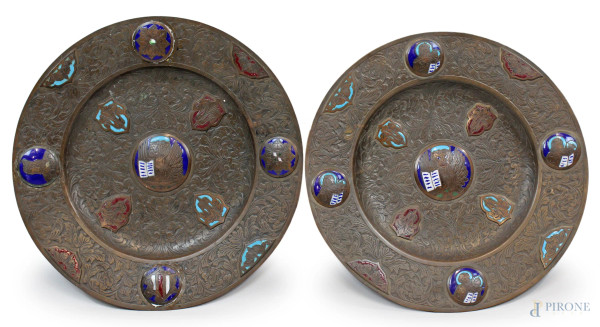 Lotto di due piatti elemosinieri in bronzo cesellato con particolari smaltati, XIX secolo, diam. max cm 47
