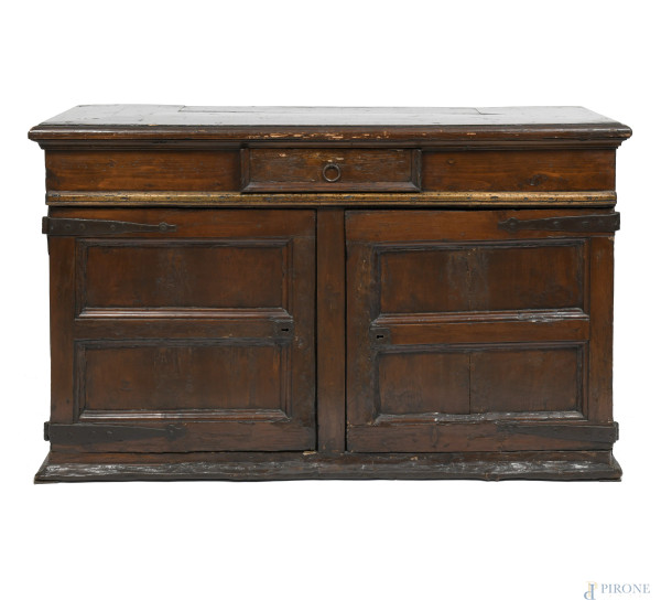 Bassa credenza in legno a doppia anta con elemento centrale fisso sormontato da cassetto, XVII secolo, cm 82x127x43, (segni di usura, scalfiture, piccole rotture, fessurazioni, difetti, parti sostituite)