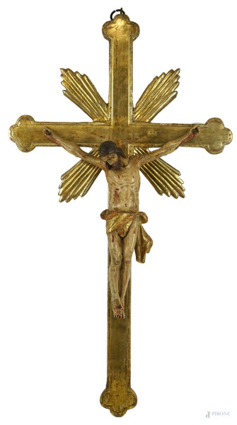 Crocifisso in legno intagliato, dorato e dipinto in policromia, XVIII secolo, cm 66x37, (difetti).