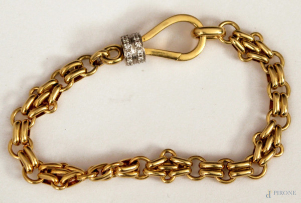 Bracciale in oro 18 kt con brillantini, marcato Pomellato, gr. 26,6, completo di custodia.