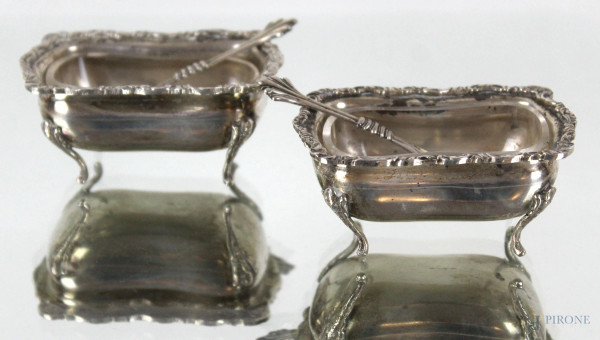 Coppia di salierine in argento con cucchiaini, corpo sagomato poggiante su piedi mossi, alt. cm 3, XX secolo, gr. 65