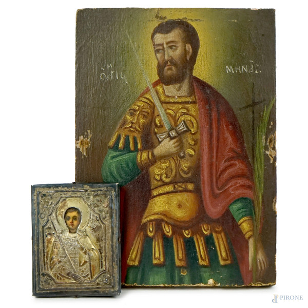 Lotto di due icone raffiguranti santi, tempera su tavola, riza in metallo argentato, misure max cm 13,5x9,5, (segni del tempo).