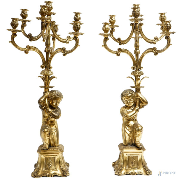 Coppia di candelabri in bronzo dorato a sette fiamme, con fusto a foggia di putto, XX secolo, altezza cm 87, (difetti)