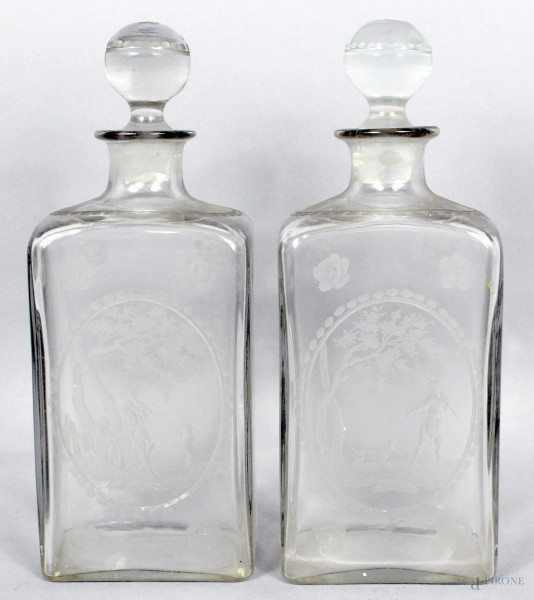 Coppia di bottiglie in vetro molato ed inciso a soggetto di fiori e paesaggi con figure, XIX secolo, cm h23,5 (sbeccatura ad un tappo)