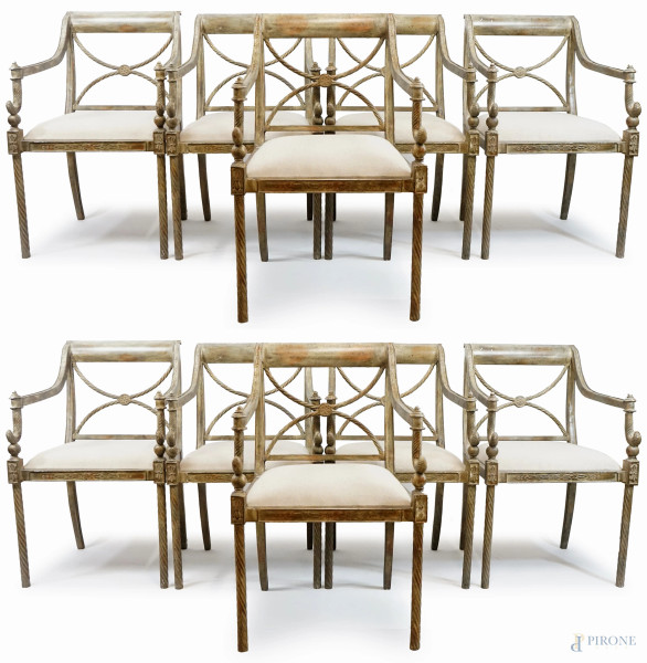 Dieci sedie in ferro battuto ed argentato, con seduta imbottita e rivestita in tessuto beige, XX secolo, cm h 90, (difetti, mancanti due applicazioni sui braccioli).
