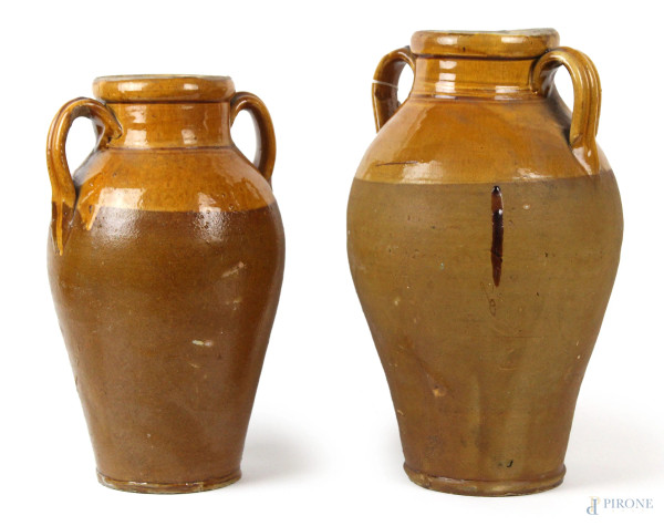 Due grandi vasi biansati in ceramica smaltata, manifattura italiana, XX secolo, alt. max cm 37, (difetti).