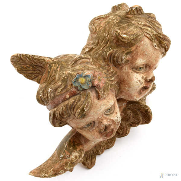 Gruppo raffigurante testa di putti in legno policromo, XX secolo, cm 22,5x30, (difetti)