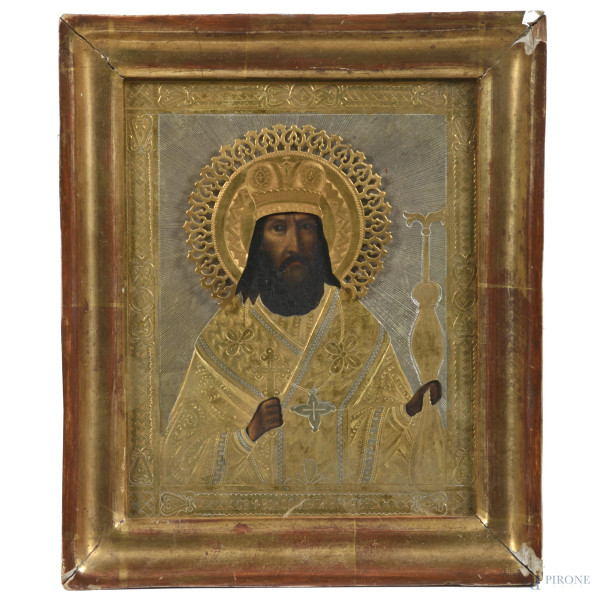 Icona ortodossa raffigurante Santo con riza in metallo dorato e argentato, XX secolo, cm 18x14, entro cornice, (segni di usura, difetti)