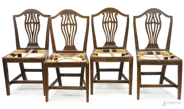 Quattro sedie in noce, XIX secolo, cartelle traforate e particolari intagliati, mancanti sedute, cm h 92,5, (difetti).