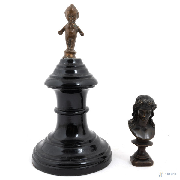 Lotto composto da un sigillo a guisa di busto femminile e scultura di putto in bronzo su base in legno laccato, XX secolo, altezza massima complessiva cm 18, (segni di usura, difetti)