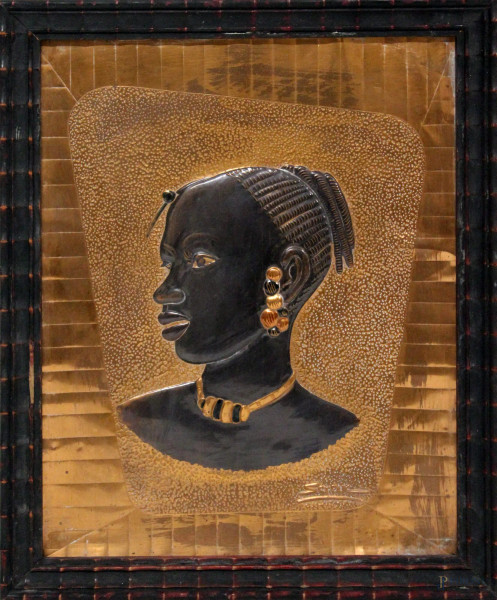 Volto di donna africana, bassorilievo su rame, firmato, cm. 25x19, entro cornice.
