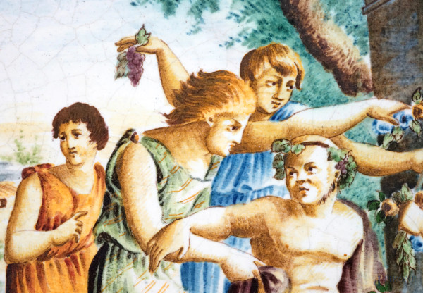 Grande piatto in maiolica policroma dipinta e smaltata, cavetto raffigurante una scena bacchica, ...