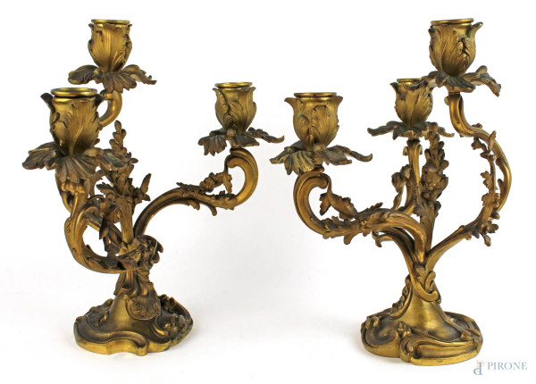 Coppia di candelabri a tre fiamme, in bronzo cesellato, fusto e bracci a ramage fogliacee, altezza cm. 33, XIX secolo.