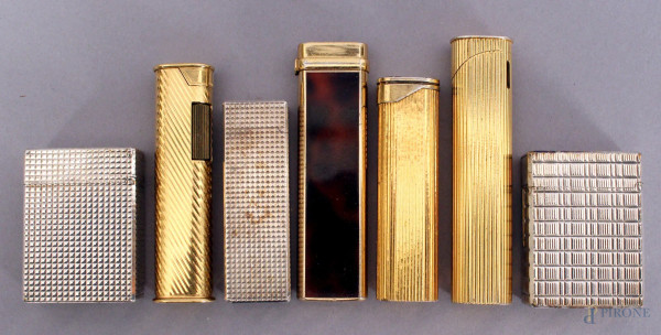 Lotto composto da sette accendini in argento e metallo dorato.