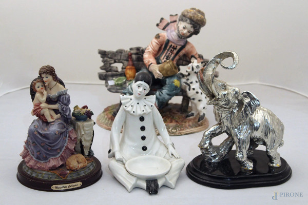 Lotto di quattro sculture diverse in maiolica e porcellana, h max 30 cm,(difetti).