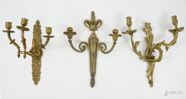 Lotto composto da tre appliques diverse in bronzo dorato, bracci sinuosi e a ramages, misure max cm 35x24,5, XX secolo, (difetti).