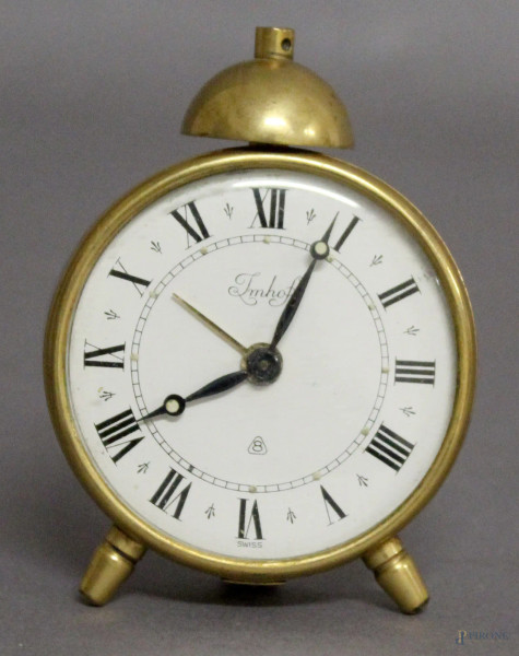 Orologio sveglia in metallo dorato, marcato Imhof, H 7 cm.