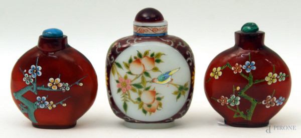 Lotto composto da tre snuff bottles in vetro dipinto a decoro floreale.