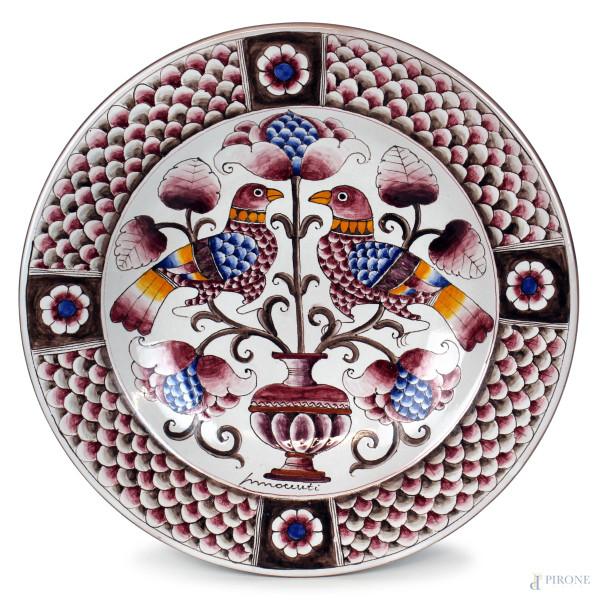 Grande piatto in ceramica policroma raffigurante vaso con fiore e coppia di volatili su rami, diam. cm 50,5, firmato Innocenti, anni '70.