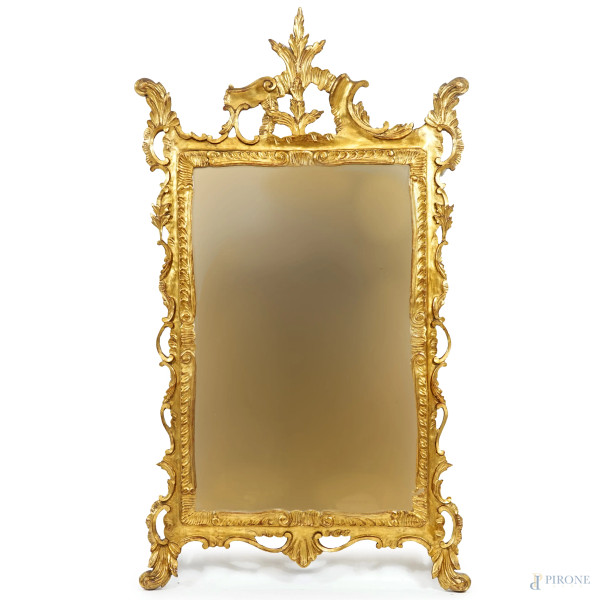 Specchiera con cornice in legno intagliato e dorato, XX secolo, cm 130x74,5, (difetti)