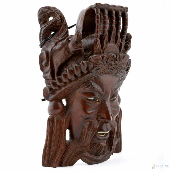 Lotto di due maschere e una scultura a rilievo in legno di teak, XX secolo, misure massime cm 25,...
