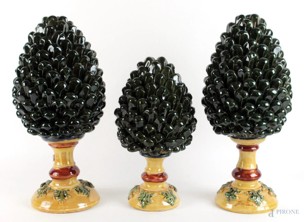 Tre pigne in ceramica smaltata verde, basi con decori a rilievo, altezza max cm. 44, (lievissimi difetti).