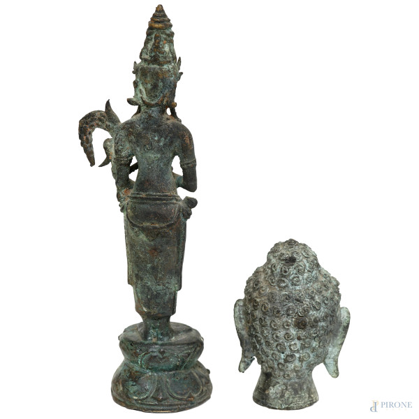 Lotto composto da una statuina in bronzo raffigurante la dea Dewi Sri e una testa di Budda in bro...