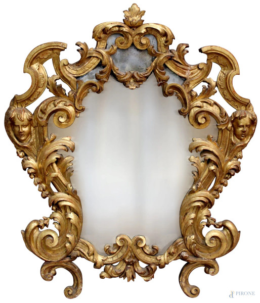 Specchiera in legno intagliato e dorato a motivi di foglie d&#39;acanto, con testine di cherubini laterali, Roma XVIII sec., cm 109 x 93.