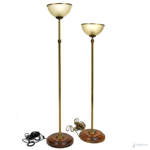 Coppia di lampade da terra con fusto regolabile in ottone e base in legno, con paralume in vetro satinato, XX secolo, altezza massima cm 192,5, (segni di usura, da revisionare)