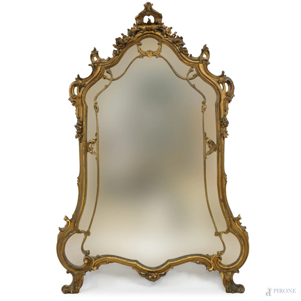 Specchiera di linea sagomata in legno intagliato e dorato, fine XIX secolo, misure ingombro cm 122,5x70,5, (difetti).