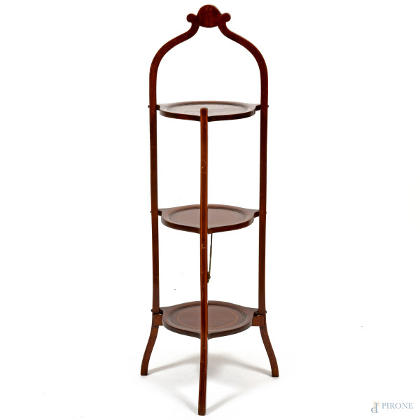 Servomuto in mogano poggiante su tre piedini e dotato di tre ripiani circolari. Ripiegabile, XX secolo, cm 95x29x26,5, (difetti)