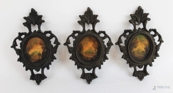 Lotto di tre miniature ad assetto ovale raffiguranti scorci di paesaggi con alberi, olio su compensato, cm 5x6, entro cornici in bronzo brunito.